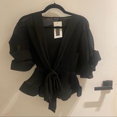 The Perfect Top For A Fancy Night Out! Never Worn (Still Has Tag From The Boutique). It Really Is A Statement Piece! Flirty Black Party Top, Flirty Black Top For Date Night, Elegant Black Top For Night Out, Glamorous Black Tops For Spring, Flirty Black Top For Going Out, Elegant Black Top For Going Out, Black V-neck Blouse For Night Out, Flirty Black Blouse For Date Night, Glamorous Black Blouse For Date Night