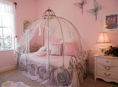 a bedroom with pink walls and white furniture