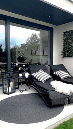 a black and white couch sitting on top of a patio