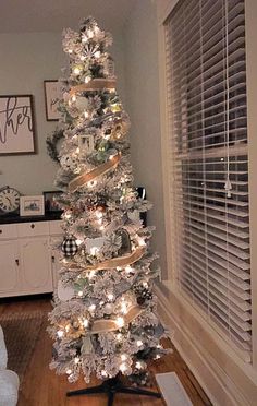 a white christmas tree decorated with lights and ornaments