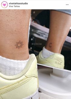 a person with a small sun tattoo on their ankle