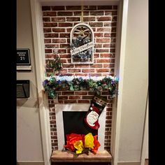 a fireplace decorated for christmas with stockings and stocking