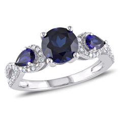 Declare your eternal love with this 3-Stone Engagement Ring. Sparkling in lustrous sterling silver, it features an elegant openwork design that showcases 2 1/3ct round-cut created blue sapphire at the center. It also features pear-cut created blue sapphire gemstones with prong-set 1/6ct diamonds shimmering along the sides. This women's engagement ring is an excellent pick for engagements, anniversaries or just as a surprise to remind that special someone how much you care. It will absolutely daz Blue Diamond Wedding Ring, Real Engagement Rings, Infinity Engagement Ring, Fashion Rings Silver, Cubic Zirconia Engagement Rings, 3 Stone Engagement Rings, Diamond Halo Ring, Sterling Silver Engagement Rings, Morganite Engagement Ring