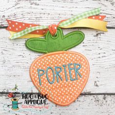 an orange and green patch with the word porter hanging from it's side on a white wooden surface