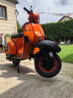 an orange scooter parked in front of a house