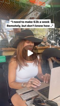 a woman sitting in front of a laptop computer wearing a cowboy hat and holding a cell phone