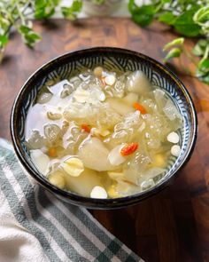 a bowl filled with soup sitting on top of a wooden table