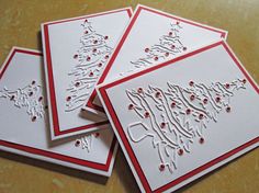 three christmas cards with white and red designs