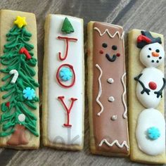 four decorated cookies sitting on top of a table