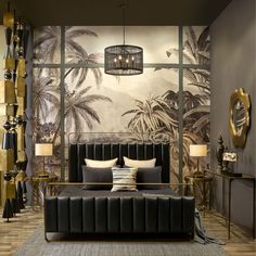 a black and gold bedroom with palm trees on the wall behind the bed, two lamps hanging from the ceiling