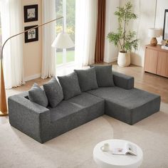 a living room with a large gray sectional couch