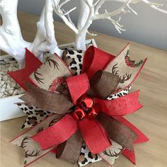 a red bow sitting on top of a wooden table