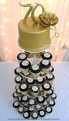 there is a cake and cupcakes on top of each other in the shape of a tower