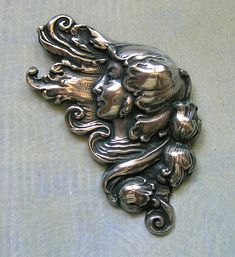 Large Vintage Sterling Art Nouveau Pin, Old Nouveau Pin, Vintage Nouveau Pin With Woman This is a beautiful Art Nouveau repousse sterling silver woman with flowing hair and a floral border brooch pin.  The woman is gorgeous and the pin has nice detail.  The pin is marked "sterling" on the back.  The pin has a safety clasp. Condition:  Overall, the pin is in good condition.  The pin has a nice patina and the pin clasp works well.    Weight:  19.7 grams Measurements:  1 3/4" wide by 2 1/2" long (#4449) Flash Ideas, Flowing Hair, Floral Border, Vintage Pins, Brooch Pin, Beautiful Art, Art Nouveau, Put On, Brooches