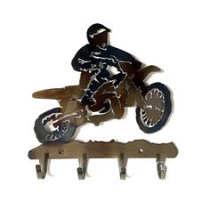 a metal sculpture of a motorcyclist on a bike