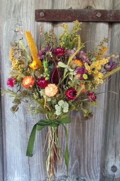 a bouquet of flowers sitting on top of a wooden door