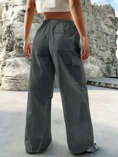 Experience the perfect blend of comfort and style with our Flap Pocket Drop Waist Cargo Pants. These pants are designed for those who appreciate functionality without compromising on fashion. Whether you're exploring the city streets or simply lounging at home, these cargo pants offer versatility for any occasion. Pair them with a casual t-shirt for a laid-back vibe, or dress them up with a button-down shirt for a more polished ensemble. Details: Type: Parachute Pants Closure Type: Drawstring Wa Summer Wide Leg Pants For Outdoor Activities, Comfortable Full Length Bottoms With Pockets, Utility Travel Pants With Side Pockets, Utility Bottoms With Pockets For Travel, Utility Pants With Cargo Pockets For Travel, Utility Travel Bottoms With Pockets, Comfortable Solid Pants With Pockets, Comfortable Solid Color Pants With Pockets, Comfortable Full-length Pants With Pockets