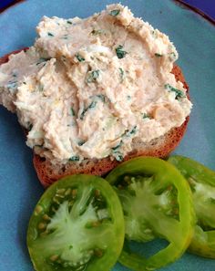 a blue plate topped with a sandwich and sliced green peppers