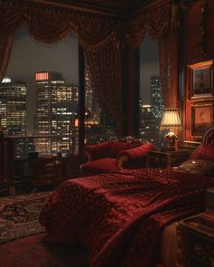 a bedroom with red velvet furniture and city lights in the window sill, along with a view of skyscrapers at night