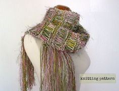 a white mannequin wearing a multicolored scarf