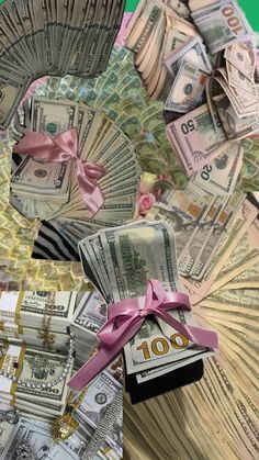 money is being thrown into the air with pink ribbons