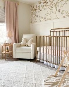 a baby's room with a crib and chair