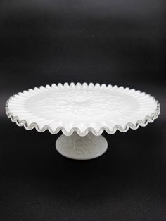 a white plate sitting on top of a black table