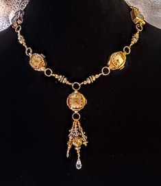 This  necklace has 5 beautiful vintage watches, at least one of which is stamped 10K gold plated bezel. Dangling form the center watch are gold filled beads as well as silver tone beads and some clear crystals for sparkle. Links that I made to separate the other watches are also comprised of gold tone, gold filled and silver beads. The clasp is a large lobster claw clasp. This one is stunning! These necklaces make a statement and are perfect for anyone who loves vintage or steampunk style. Wear Bronze Vintage Charm Jewelry For Anniversary, Bronze Jewelry With Vintage Charm For Anniversary, Timeless Antique Gold Medallion Jewelry, One-of-a-kind Heirloom Gold Jewelry, Vintage Gold Beads Jewelry Gift, Antique Gold Metal Jewelry For Anniversary, One Of A Kind Antique Jewelry For Anniversary, Timeless Yellow Gold Jewelry With Vintage Charm, Anniversary Antique Gold Metal Jewelry