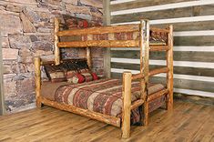 a wooden bunk bed sitting on top of a hard wood floor next to a stone wall