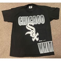 "Vintage 1993 Large Chicago White Sox MLB Lee Sport Double Sided Graphic Print T-Shirt in Black. Made in the USA out of 100% Cotton. Shipped with USPS First Class Package. Don't miss out; once it's gone, IT'S GONE! Product Condition: Pre-owned and in excellent condition! No stains, rips, or tears. Please see pictures. Stay in the loop by following my IG @Retro_ology for the latest vintage gear! Measurements: All measurements taken flat. Please compare measurements as we do not accept returns for items that do not fit. Length (Top of Collar to Hem): 28 1/2\" Pit to Pit: 21\" (NOTE: Please DO NOT rely on the listed size for your correct fit. Designers often use different measurements for sizes depending on the overall look they desire, and pre-worn Items may have been altered or slightly shr Chicago White Sox Outfit Women, Chicago White Sox World Series Ring, Vintage Graphic Print T-shirt For Baseball Season, Red Sox Shirt, Shop Fans, White Sock, Chicago White Sox, Mlb, Graphic Prints