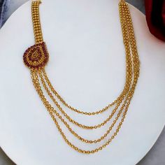 Check out the trendy Ruby Mango Mugappu Pendant Layer Mala for women! This gold-plated four-strand ball chain is the perfect accessory for any wedding or festive occasion. With ruby-stone studded mango design side pendant and an adjustable back chain, it's sure to make a bold statement. Don't hesitate to pair it with a saree or ethnic outfit for a stunning look! Mango Design, Cz Stone Necklace, Ruby Beads, Multi Layer Necklace, Layered Chains, Neck Jewellery