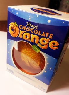 there is a box of chocolate oranges on the table