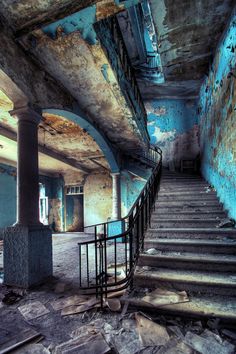 an old building with stairs and graffiti on the walls is being used as a postcard