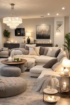 a living room filled with lots of furniture and candles on the table in front of it