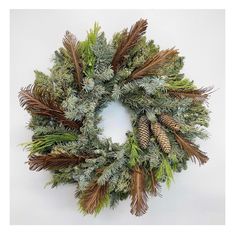 a wreath with pine cones and evergreen needles