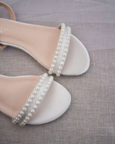 Classy satin flat sandals with a mini pearls and ankle strap. Effortless yet adorable to wear on your favorite occasion. Can be pair with dress or casual look.DETAILS:COLORS AVAILABLE: IvoryUPPER: Synthetic upper and liningMATERIALS: Mandmade outsoleSTYLE NAME: MADDY Elegant Beaded Flat Sandals, Summer Flat Heel Bridesmaid Wedding Shoes, Bridal Shower Pearl Embellished Ankle Strap Sandals, Summer Wedding Shoes With Flat Heel For Bridesmaids, Summer Bridesmaid Wedding Shoes With Flat Heel, Flat Summer Wedding Shoes For Bridesmaids, Beaded Open Toe Sandals For Wedding, Summer Open Toe Pearl Wedding Shoes, Summer Wedding Pearl Open Toe Shoes