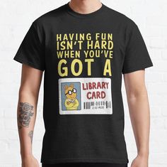 a man wearing a black t - shirt that says having fun isn't hard when you've got a library card