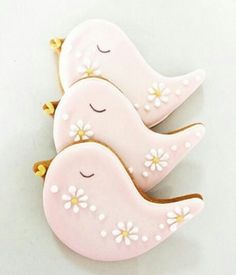 two pink birds with white flowers on them