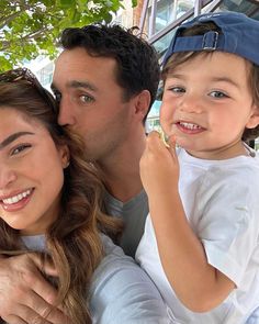 a man, woman and child posing for a photo