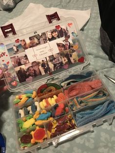 a plastic container filled with lots of candy and candies on top of a table