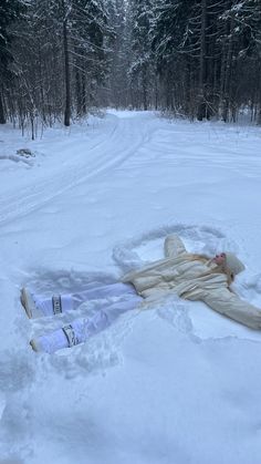 a person laying in the snow with their head down