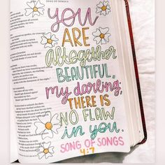 an open bible with flowers and the words you are awesome written in pink, green, yellow, and blue