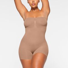 This strapless shortie solution is perfect for cinching your waist, holding in your tummy and core, and smoothing your thighs under mini skirts and dresses. Features pique stitching that supports your bust, an open gusset, and removable adjustable straps that you can wear as shoulder straps, cross back, or as a halter. | SKIMS Strapless Shortie Bodysuit | Medium Neutral | Seamless Sculpt Corset Bodysuit, Plunge Bodysuit, High Neck Bodysuit, Scoop Neck Bodysuit, Skirts And Dresses, Square Neck Bodysuit, Tank Bodysuit, Top Band, And Dresses