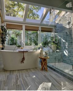 a bathroom with a large bathtub next to a walk in shower and two windows