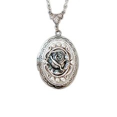 The antique style silver plated floral engraved locket is 30mmx25mm. The antique style silver rose the front of this locket. The locket is connected to a 24 inch chain by a rosary style connector. The little rose is vary detailed, The locket is oval in shape and has a lace filigree edging that frames the outside. The locket is packaged in a lovely little silhouette box, set on a soft piece of white cotton. ♥ * ♥ * ♥ * ♥ * ♥ * ♥ * ♥ * ♥ © Original design by Twilight's Castle Thank you for visitin Rose Locket, Silver Flower Pendant Jewelry With Rose Design, Silver Vintage Charm Necklace For Mother's Day, Mother's Day Silver Necklace With Vintage Charm, Vintage Jewelry With Rose Design Flower Pendant, Vintage Rose Design Flower Pendant Jewelry, Rose Vintage Sterling Silver Jewelry, Vintage Sterling Silver Jewelry With Rose Design, Adjustable Silver Locket Necklace For Gifts