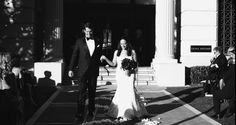 a bride and groom walking down the aisle at their wedding ceremony in black and white