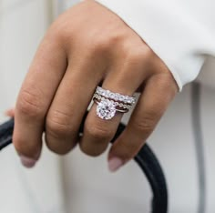 a close up of a person's hand holding a ring