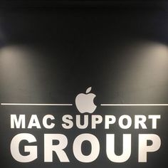 the mac support group logo is displayed on a wall