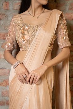 Beige pre-draped saree in a solid base with tiered layers and side drape. Comes with padded blouse embellished with 3D floral sequin and beads. - Aza Fashions Draped Blouse With Zari Work For Wedding, Silk Draped Blouse With Mirror Work, Draped Wedding Blouse With Zari Work, Silk Wedding Blouse With Draped Sleeves, Fitted Blouse Piece With Draped Sleeves For Reception, Traditional Blouse With Draped Sleeves For Reception, Bollywood Style Blouse With Draped Sleeves For Wedding, Festive Wedding Blouse Piece With Draped Sleeves, Festive Wedding Blouse With Draped Sleeves