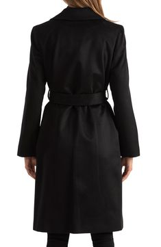 A super soft wool and cashmere blend composes this belted coat for cozy style. 40" length Long sleeves Front closure 95% wool, 5% cashmere Dry clean Made in USA
 Model stats: 5'10" height, 32" bust, 25" waist, 36" hip. Classic Fitted Outerwear With Belt Detail, Classic Black Outerwear With Belted Cuffs, Tailored Outerwear With Belt Detail For Work, Tailored Formal Outerwear With Belt Detail, Black Wool Coat With Belted Cuffs, Office Wool Coat With Notch Lapel And Belted Cuffs, Black Belted Pea Coat For Work, Black Belted Long Pea Coat, Classic Formal Outerwear With Belt Detail